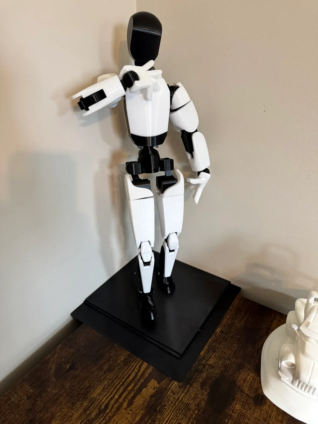 Articulated 3D-printed figure with movable joints on a display plinth